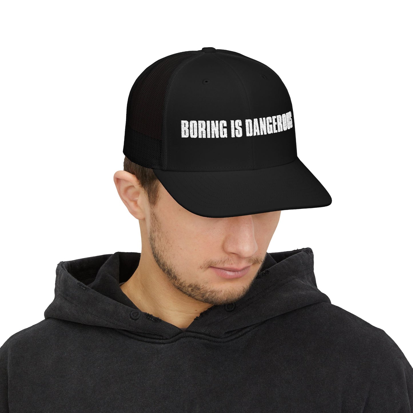 Man wearing black hat with Boring is Dangerous white text.