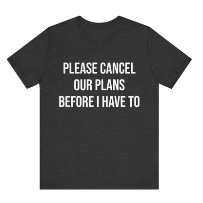 Black t-shirt with white text 'PLEASE CANCEL OUR PLANS BEFORE I HAVE TO' on a white background