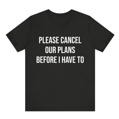 Black t-shirt with white text 'PLEASE CANCEL OUR PLANS BEFORE I HAVE TO' on a white background