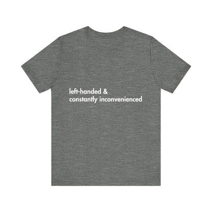 Gray t-shirt with white text 'left-handed & constantly inconvenienced' on a white background