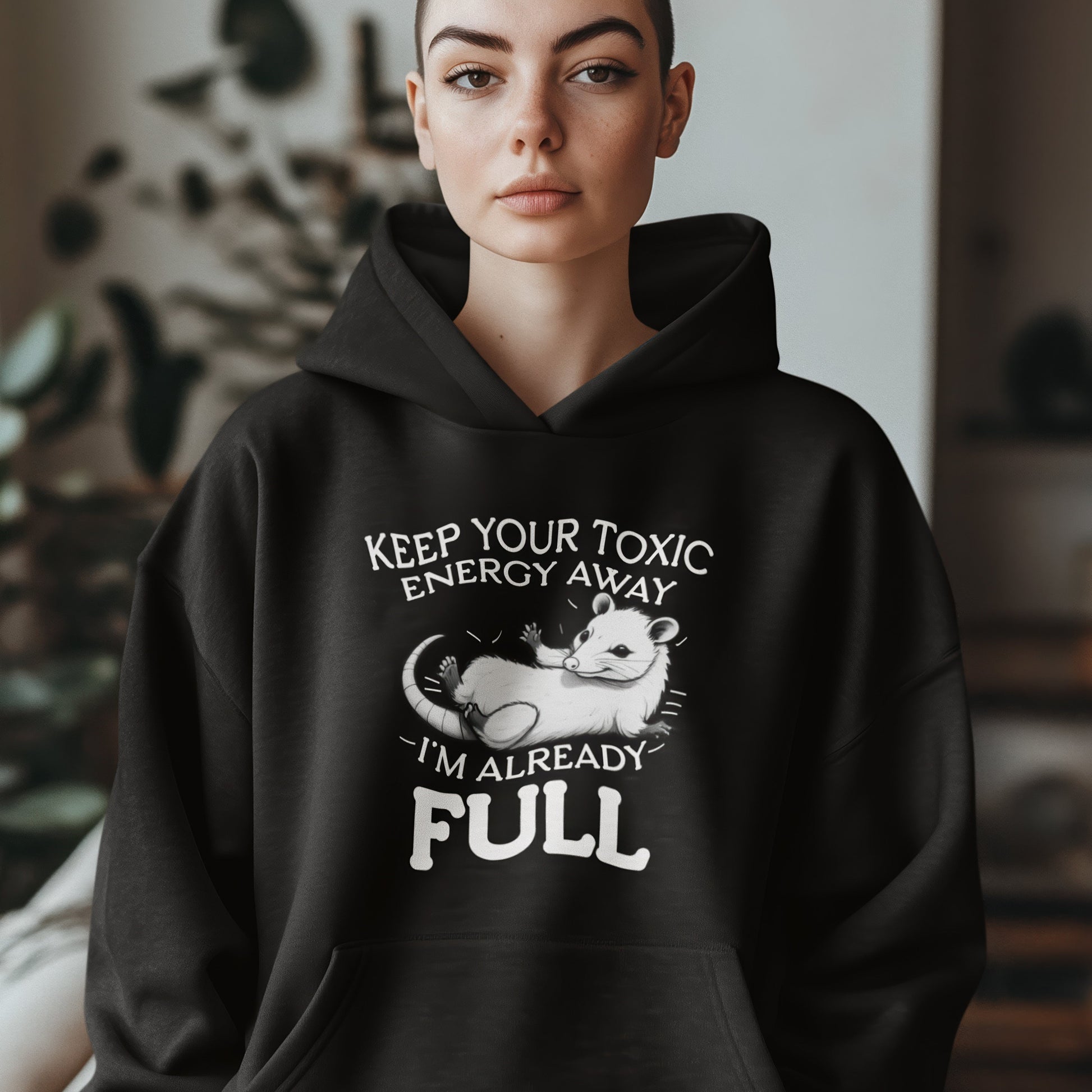 Person wearing a black hoodie with a humorous design and text.