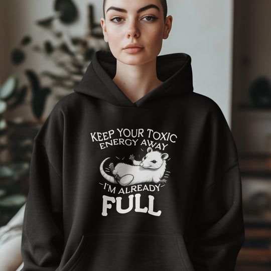 Person wearing a black hoodie with a humorous design and text.