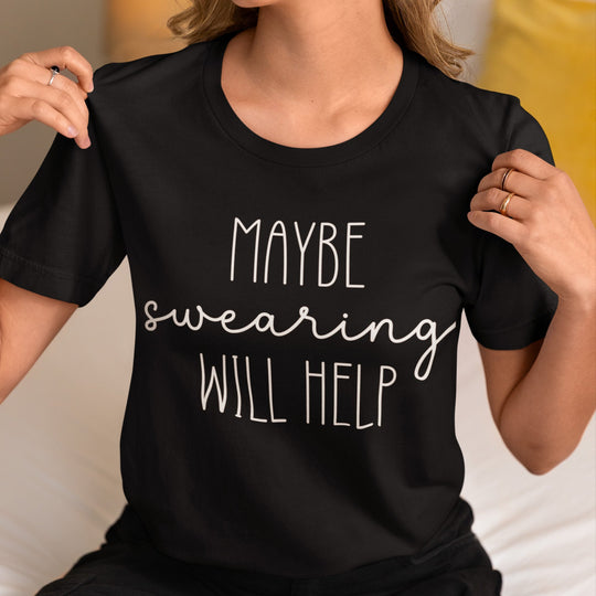 Person wearing a black t-shirt with 'MAYBE swearing WILL HELP' text.