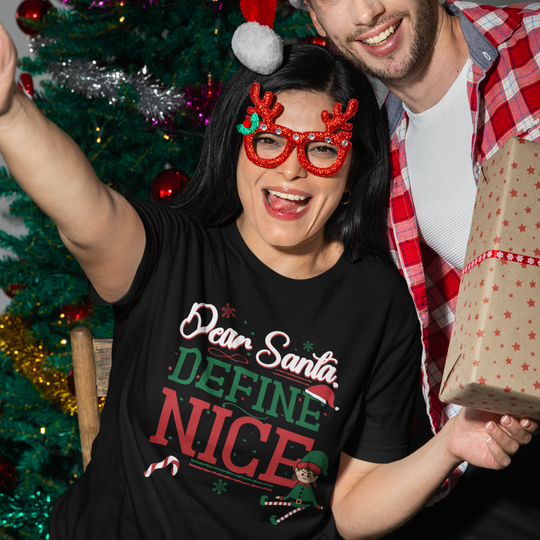 Two people celebrating Christmas with a decorated tree in the background.