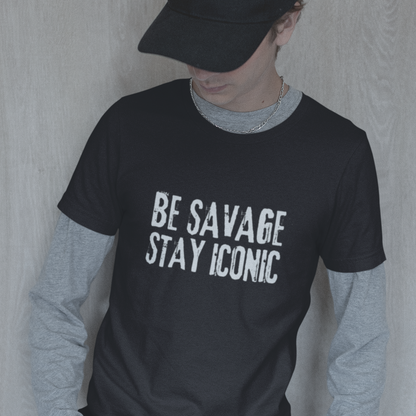 Person wearing a black t-shirt with 'BE SAVAGE STAY ICONIC' text, gray long-sleeve shirt underneath, and black cap.