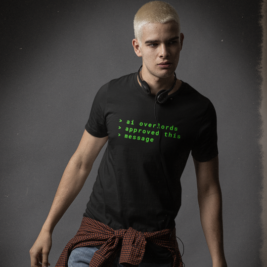 Man wearing a black t-shirt with text and a brown apron on a dark background